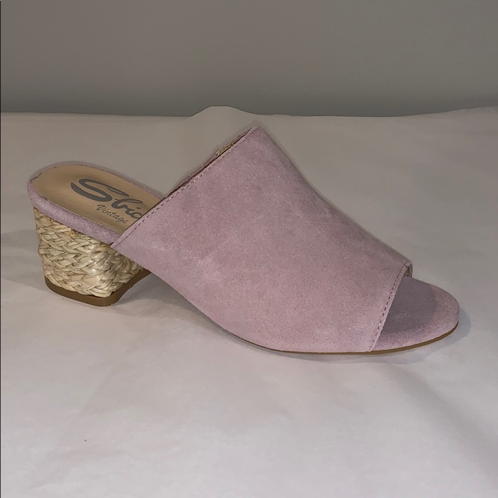 Blush mules with raffia heel.